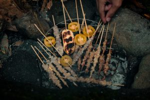 a grill with skewers of food on top of it