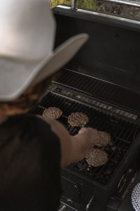 person holding brown cookies on brown tray